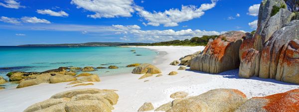 Looking across the Ocean from the rocks of Cosy Corner, Bay of fires in Tasmania on a sunny day