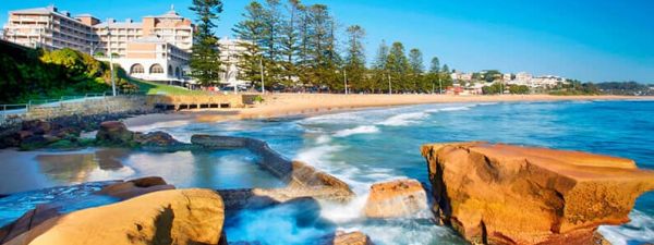 Rock pools by the ocean under bright blue sky on the central coast of NSW